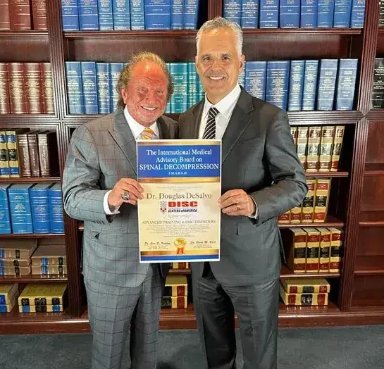 Dr. Douglas DeSalvo receiving board certification in non-surgical spinal decompression