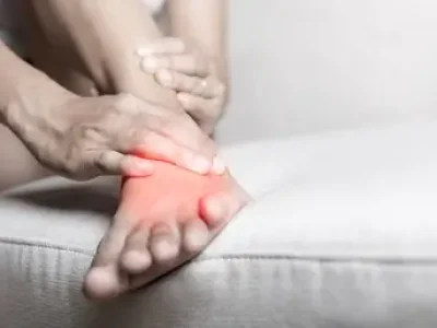 Foot,Pain,,Asian,Woman,Sitting,On,Sofa,Hold,Her,Ankle